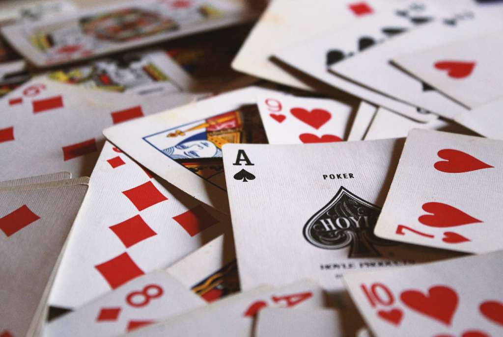 Deck of heart playing cards thrown across a table